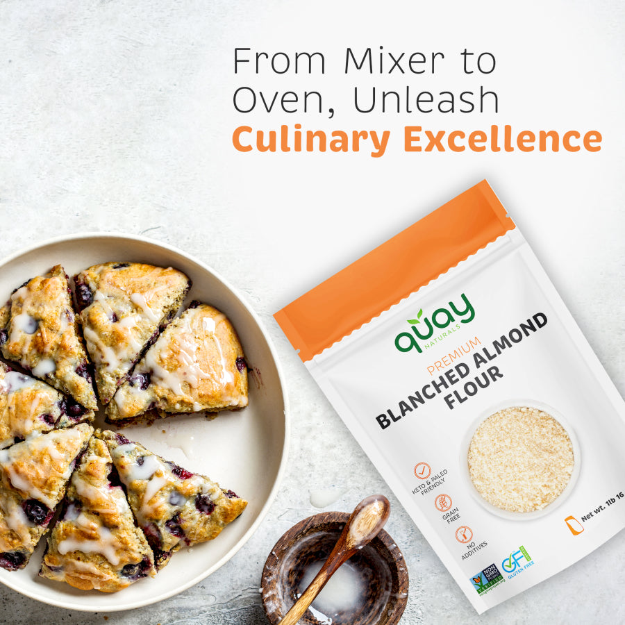 Scones with glaze and berries on a plate next to a bag of Quay Naturals Blanched Almond Flour, promoting culinary excellence.