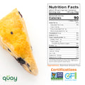 A blueberry scone stands beside a Nutrition Facts label for Blanched Almond Flour & Non-GMO and Gluten-Free certifications.