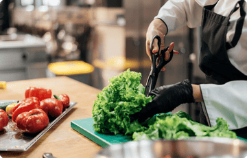 a person cut the vegetable