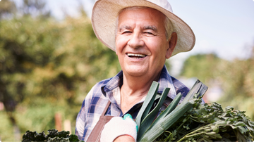 A Old Men holding vegetable