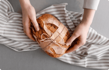 holding wrapped bread