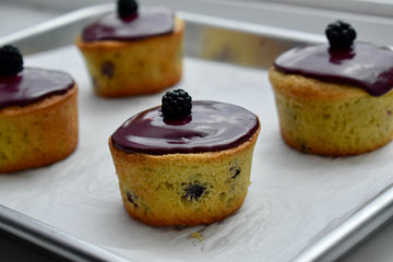 Muffins with blackberry topping on a baking tray