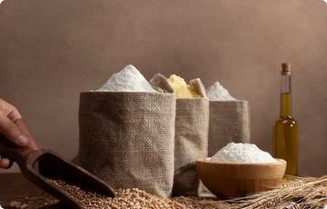 Flour, grains, and oil on a table