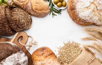 Different types of bread with grains and olives